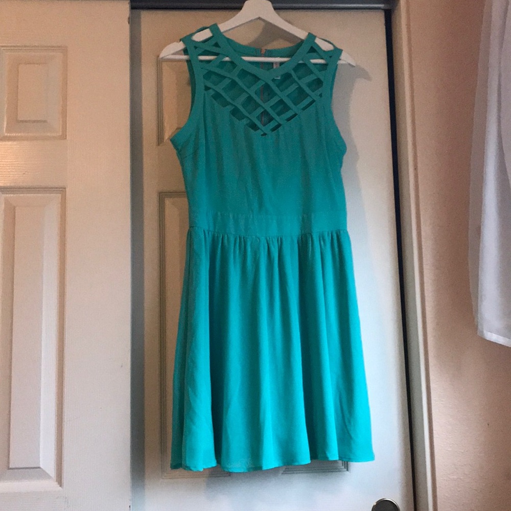 Turquoise dress with zipper and cross cross design